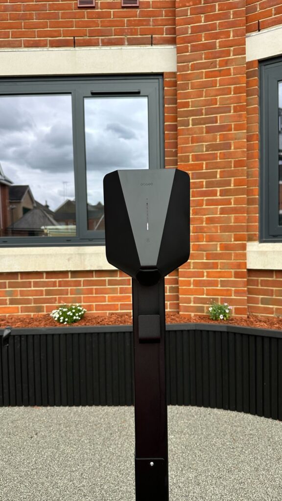 Easee EV charger on a black post