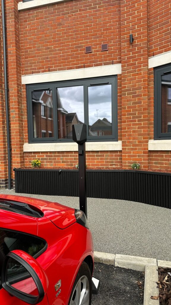 EV charging post next to a parking bay