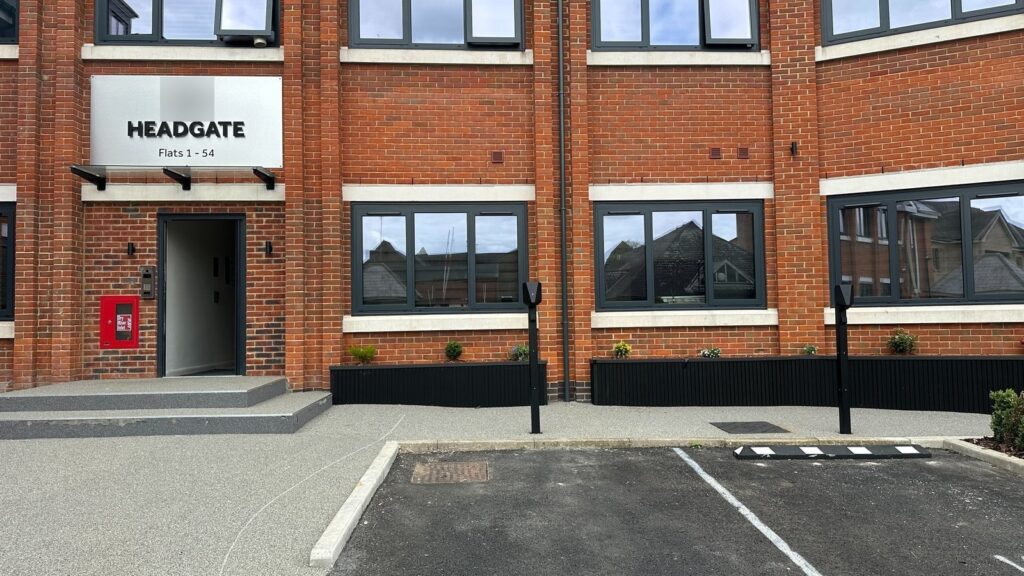Entrance to the Headgate block with two EV charging posts beside the parking bays