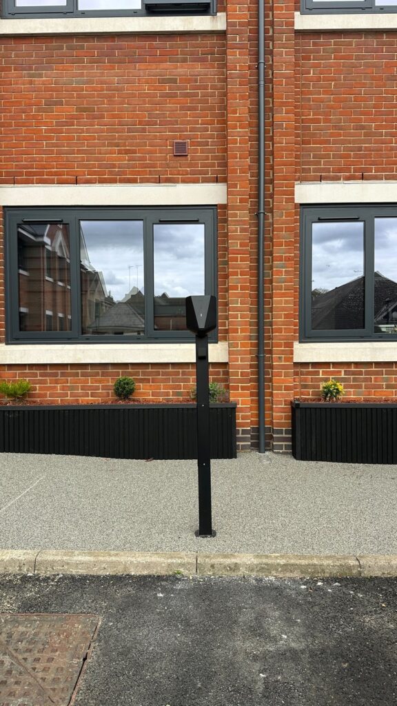 Post-mounted Easee EV charger outside a ground-floor flat