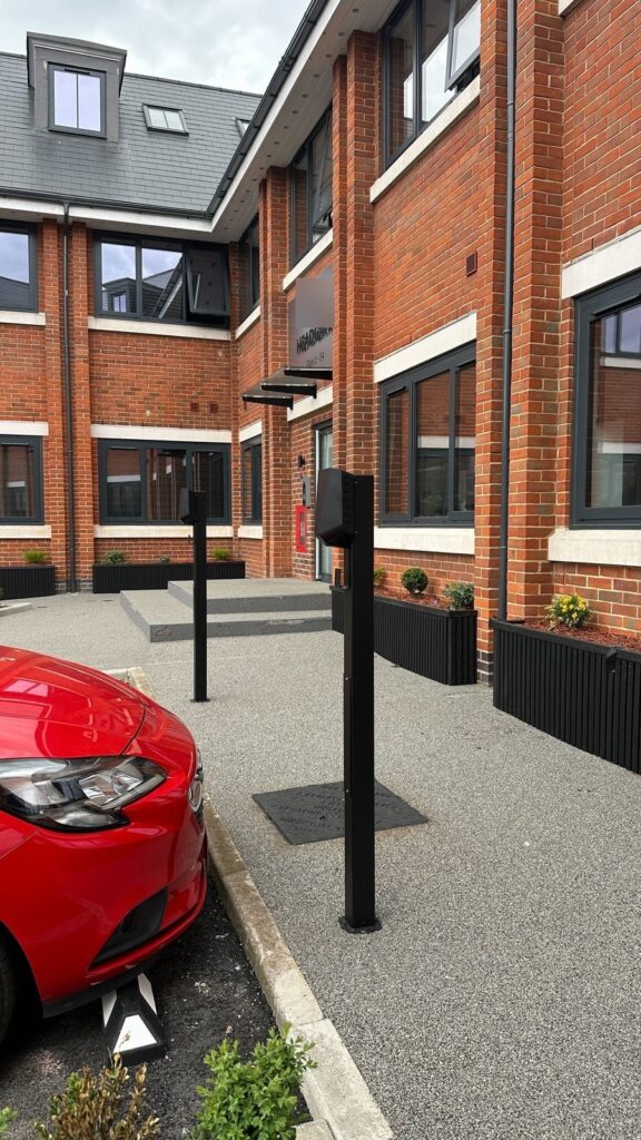 Row of EV charging posts leading to the block entrance