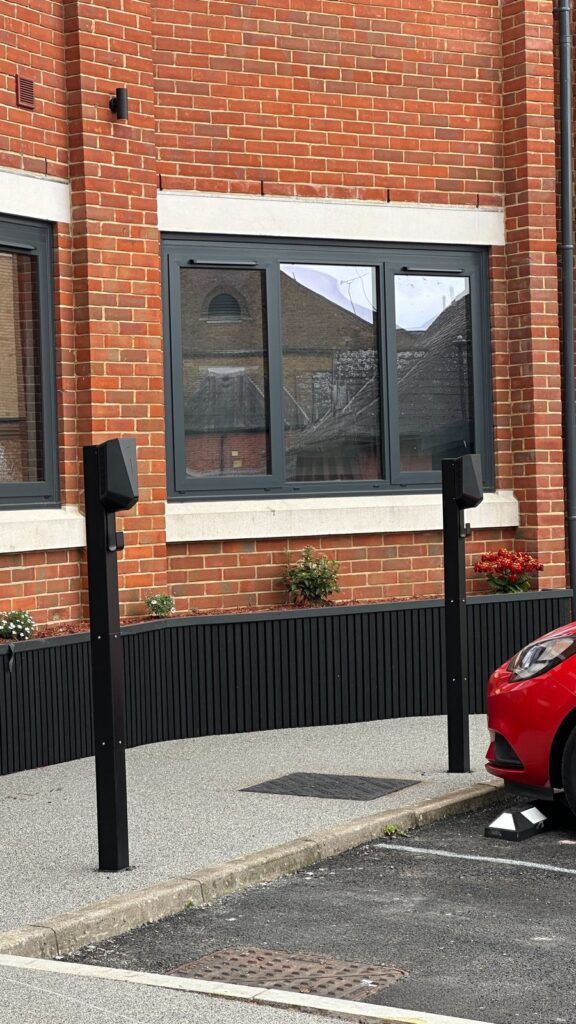 Two EV charging posts outside ground-floor flats