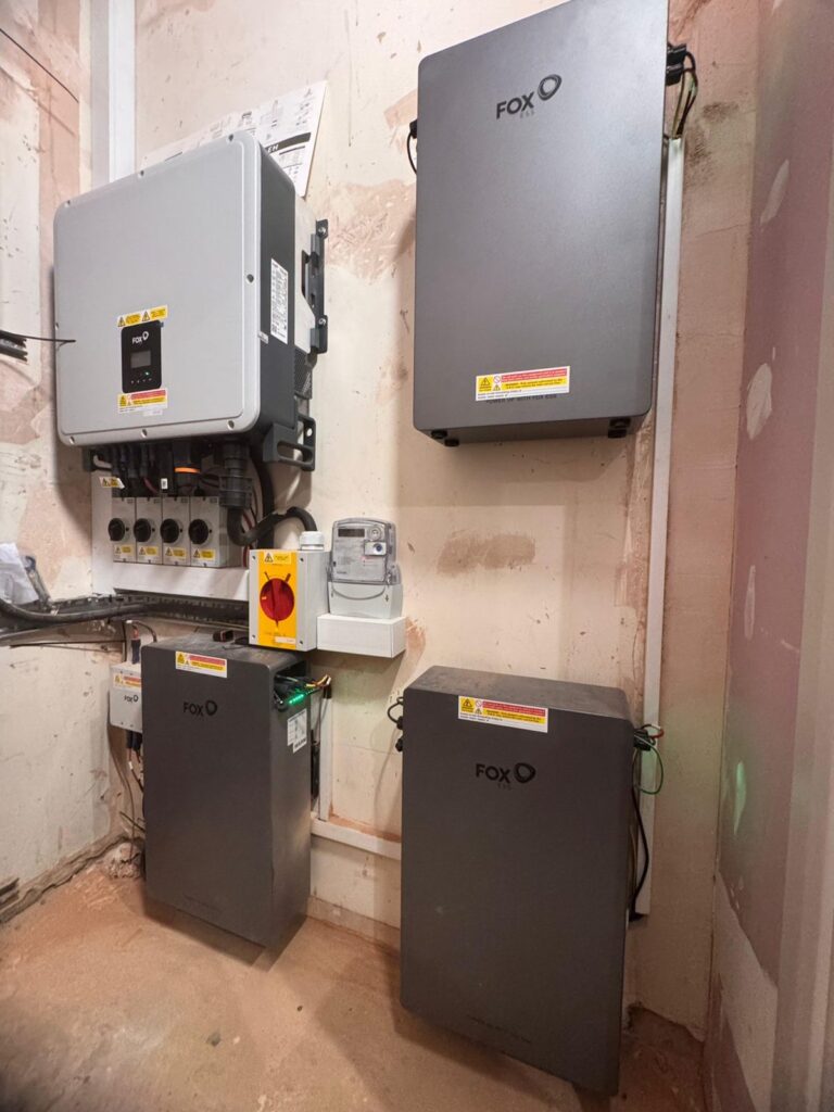 Fox ESS inverter and battery units mounted on the wall of a plant room