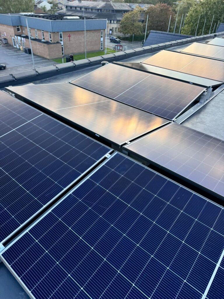 Rows of black solar panels catching the sun on a flat roof