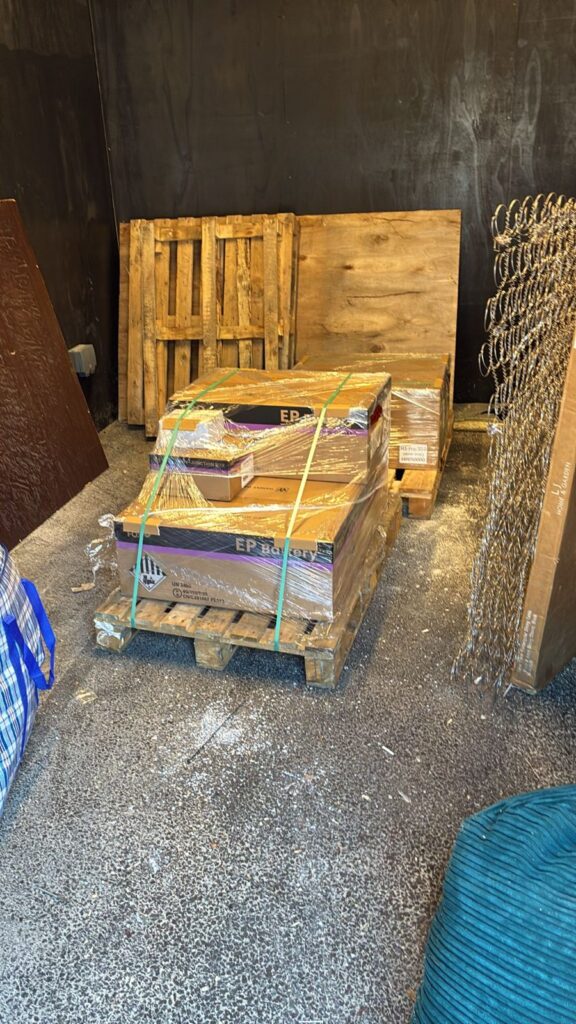Pallets of solar equipment delivered and stored on site before installation